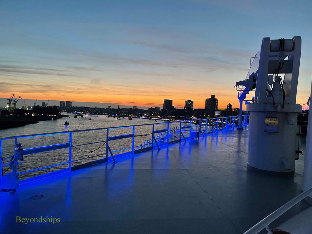 Queen Mary 2 lit in blue during Hamburg harbor event.